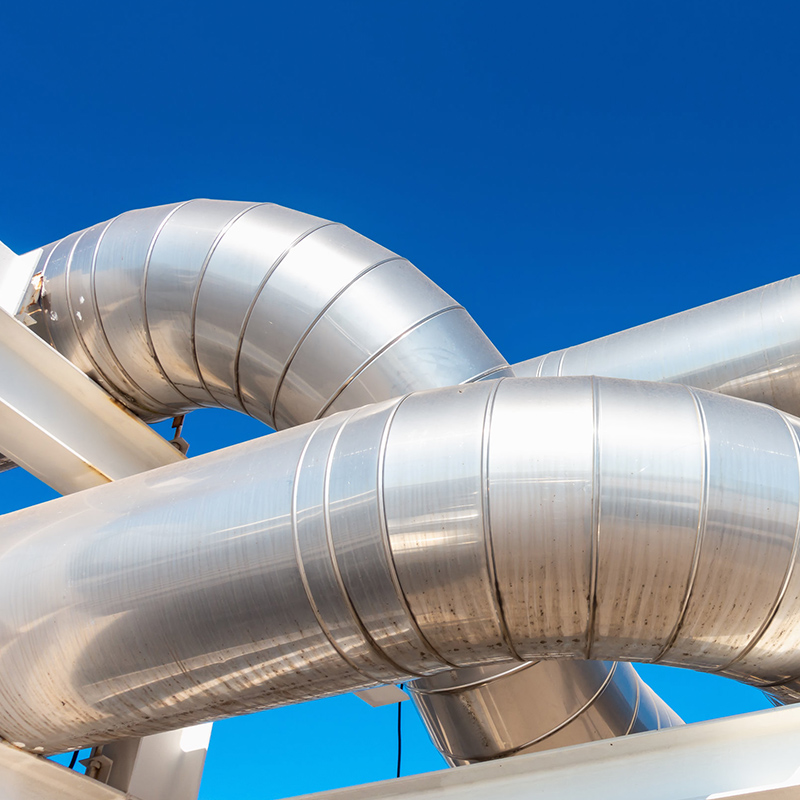 Commercial air conditioning piping with clear cloudless sky